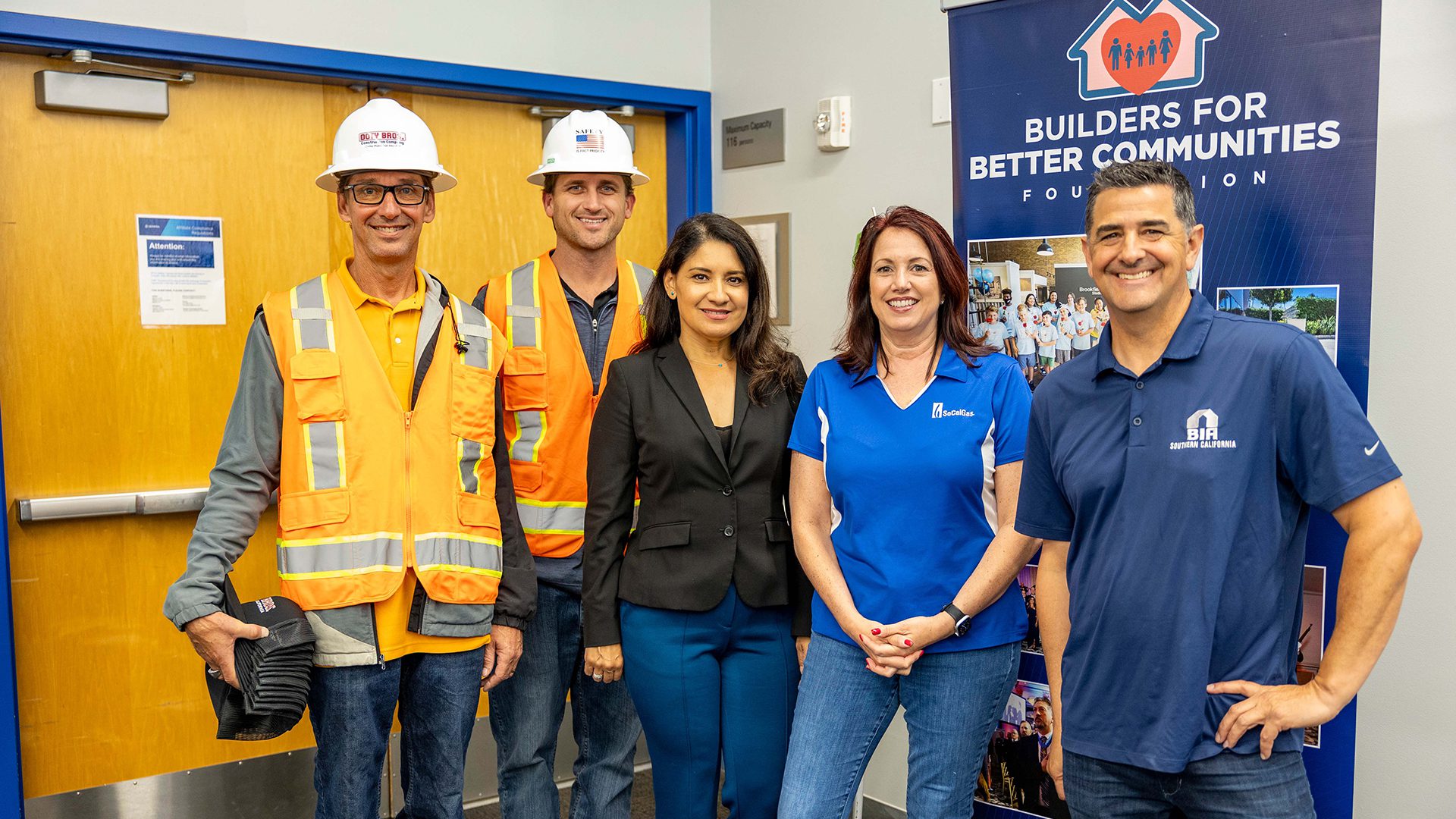 Professionals at the Builders for Better Communities Foundation event, including construction workers & representatives.